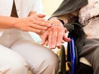 Young nurse and female senior in nursing home, the old lady sitting in a wheel chair